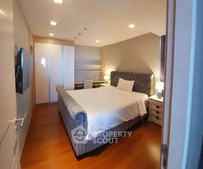 Spacious bedroom with elegant decor and ample natural light, featuring a plush bed and modern furnishings.