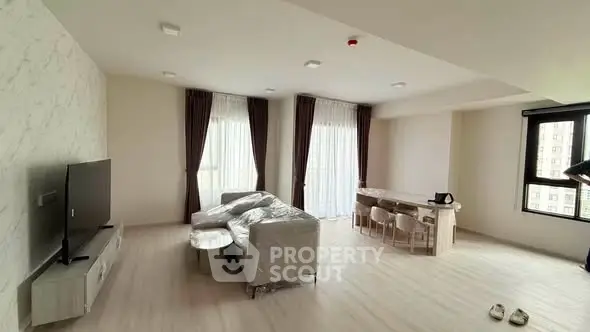 Spacious modern living room with large windows and stylish furniture