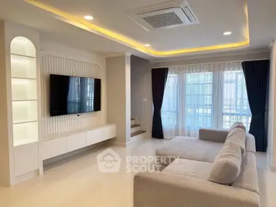 Spacious modern living room with elegant lighting and large sofa, perfect for relaxation.