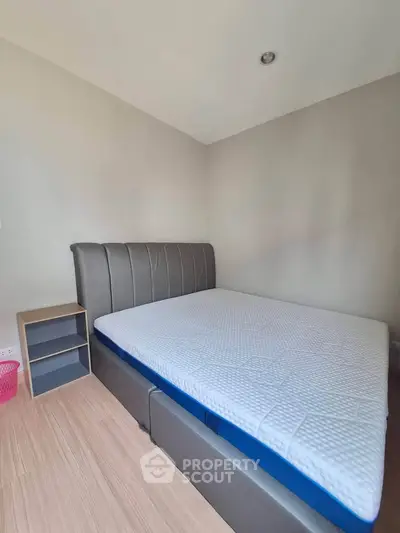 Spacious bedroom with modern bed and minimalist decor, perfect for relaxation.
