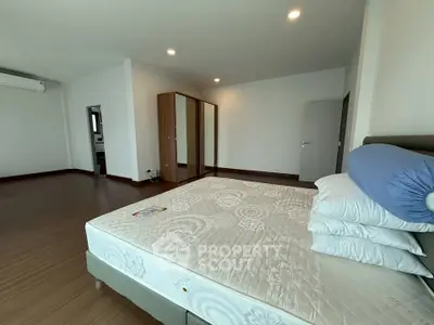 Spacious bedroom with modern design and ample natural light