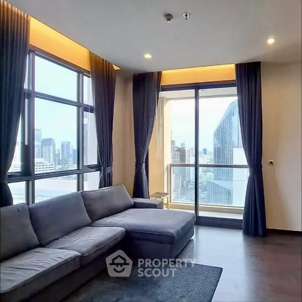 Luxurious living room with panoramic city view and elegant furnishings.
