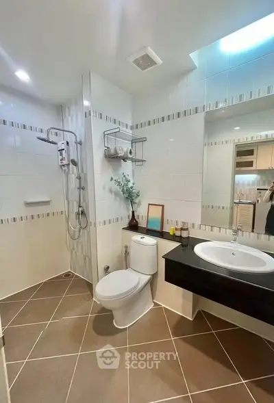 Modern bathroom with sleek fixtures and spacious shower area