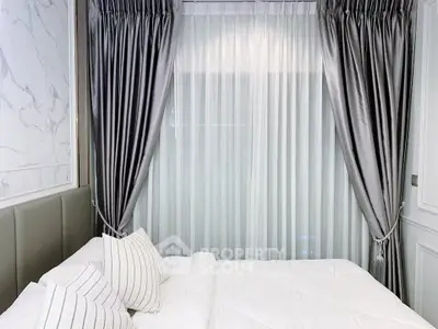 Luxurious bedroom with elegant curtains and plush bedding, perfect for relaxation and comfort.