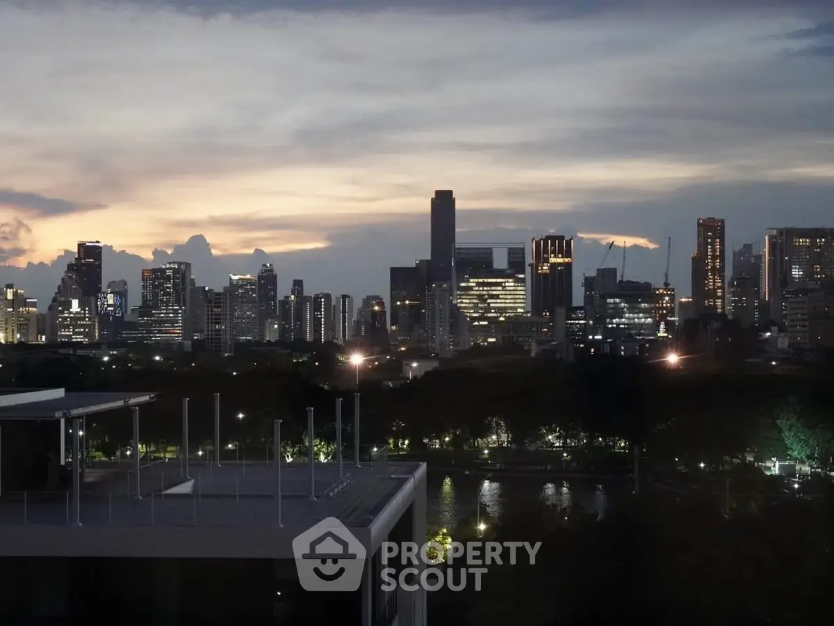Stunning city skyline view at dusk with modern high-rise buildings and serene riverfront.