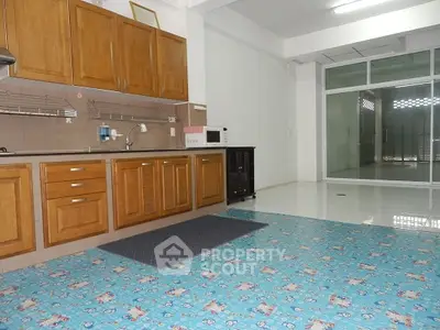 Spacious kitchen with classic wooden cabinetry and ample counter space, complemented by modern appliances and a bright, airy atmosphere.