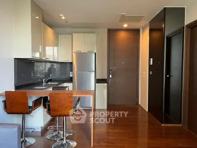 Modern kitchen with sleek cabinetry and breakfast bar in stylish apartment