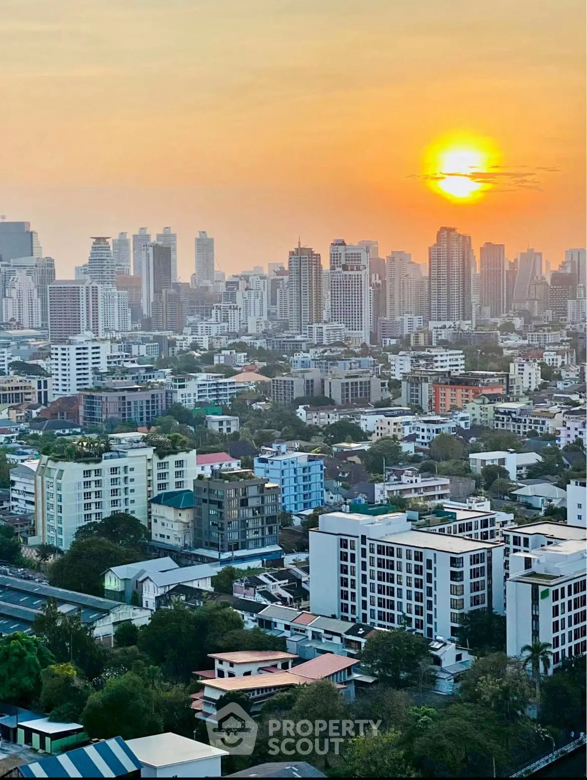 Stunning cityscape view at sunset showcasing urban skyline and residential buildings.
