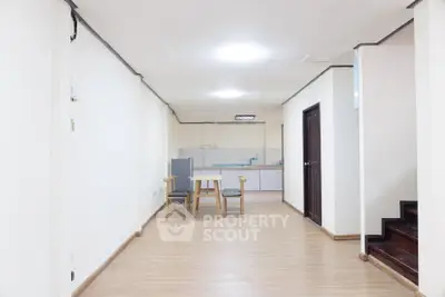 Spacious open-plan living area with modern kitchen and wooden flooring