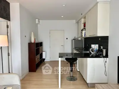 Modern open-layout kitchen with sleek cabinetry and breakfast bar in a stylish apartment.