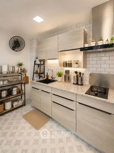 Modern kitchen with sleek cabinetry, gas stove, and stylish decor in a contemporary home.