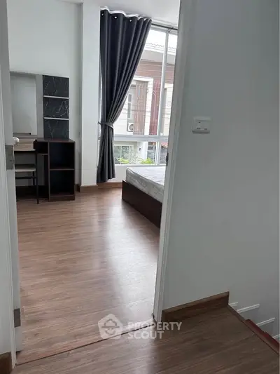 Modern bedroom with large window and stylish decor