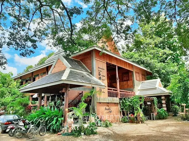 Charming rustic wooden house surrounded by lush greenery and vibrant trees, perfect for nature lovers.