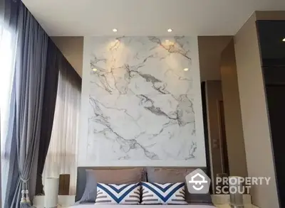 Luxurious bedroom with marble accent wall and elegant decor