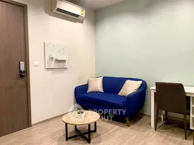 Cozy living room with blue sofa and modern decor