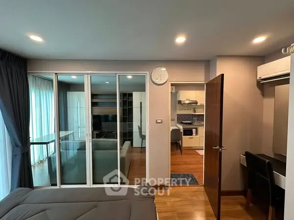 Modern apartment interior with open layout, featuring a cozy living area and stylish kitchen.