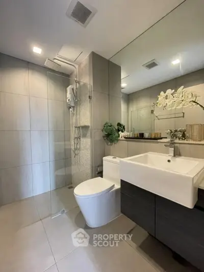 Modern bathroom with sleek fixtures and large mirror