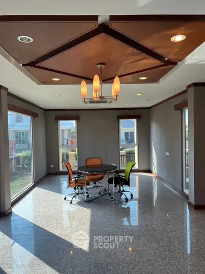 Spacious modern office space with large windows and stylish lighting