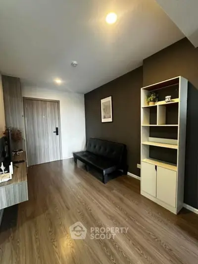 Modern living room with sleek wooden flooring and minimalist furniture design.