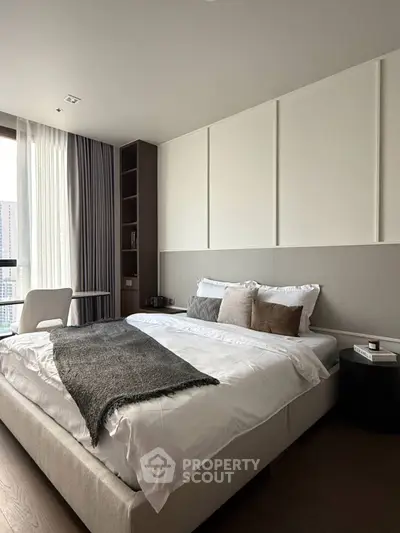 Modern bedroom with elegant decor and large window offering city view