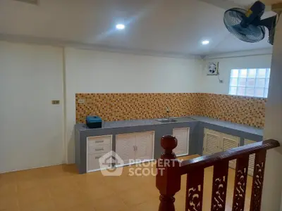 Spacious kitchen with modern tile backsplash and ample storage space