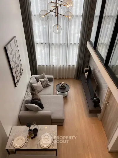 Modern living room with high ceiling and stylish decor in a luxury apartment