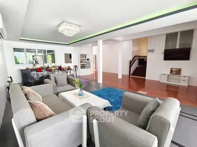 Spacious modern living room with elegant decor and open layout, perfect for family gatherings.