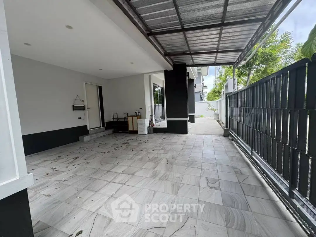 Spacious modern home entrance with covered patio and sleek design