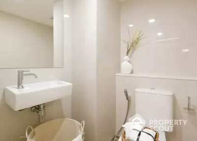 Modern bathroom with sleek sink and elegant decor in a contemporary home.