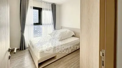 Bright and cozy bedroom with large window and modern furnishings