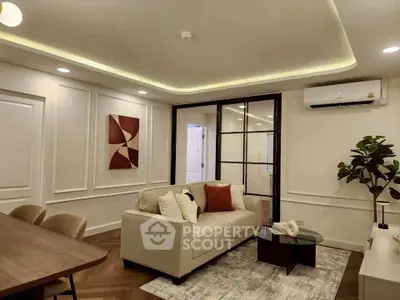 Modern living room with elegant decor and stylish furniture, featuring a cozy sofa and chic lighting.
