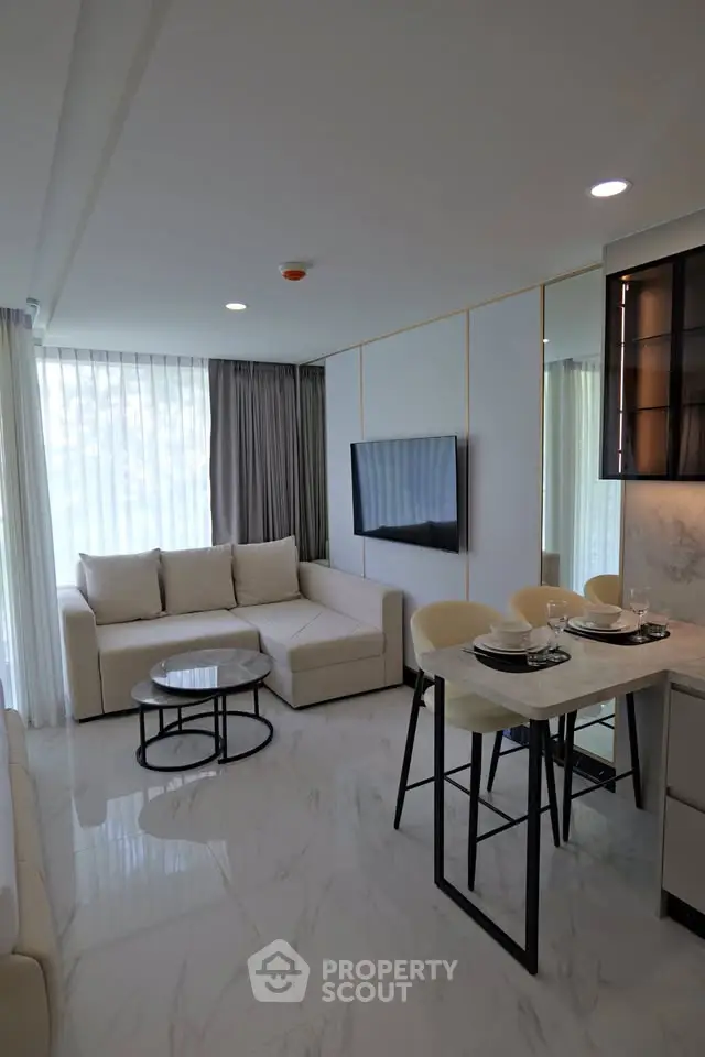 Modern living room with elegant furniture and open kitchen layout