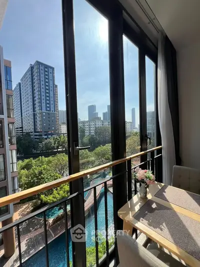 Stunning apartment balcony view overlooking cityscape and pool, perfect for urban living.