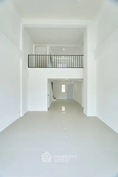 Spacious modern interior with high ceilings and mezzanine level