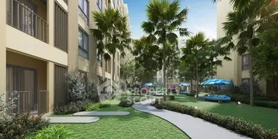 Luxurious garden view of modern apartment complex with lush greenery and palm trees.