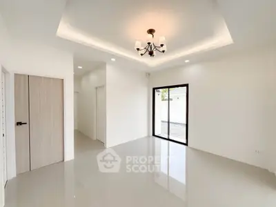 Spacious modern living room with elegant chandelier and large windows