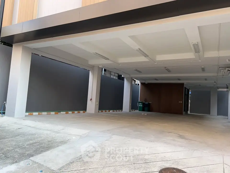 Spacious covered parking area in modern building with ample lighting and secure environment.