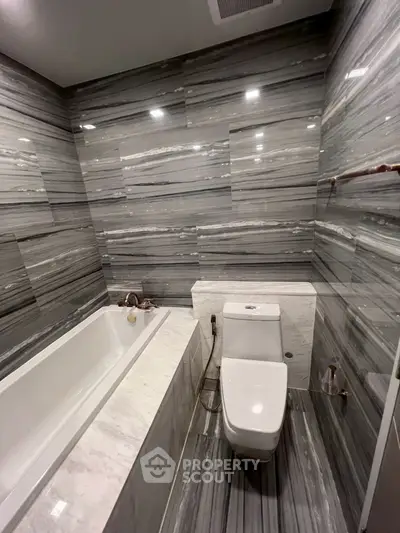 Luxurious marble bathroom with modern bathtub and toilet
