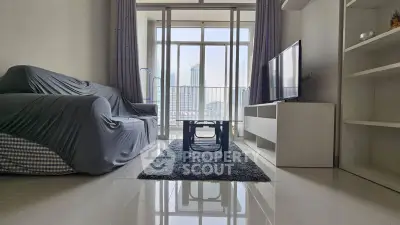 Modern living room with city view, sleek furniture, and large windows for natural light.