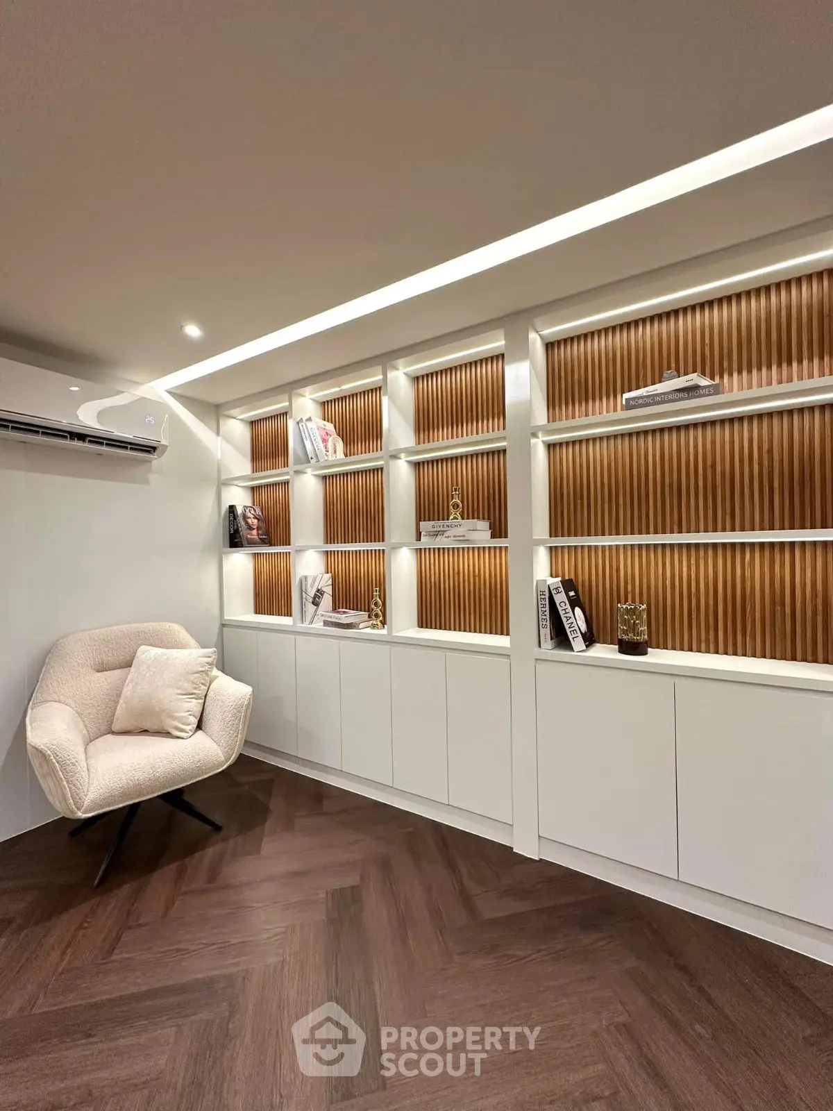 Elegant study room with modern shelving and cozy armchair, perfect for productivity and relaxation.