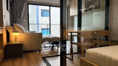 Modern apartment interior with cozy living room and dining area, featuring a large window and stylish furniture.