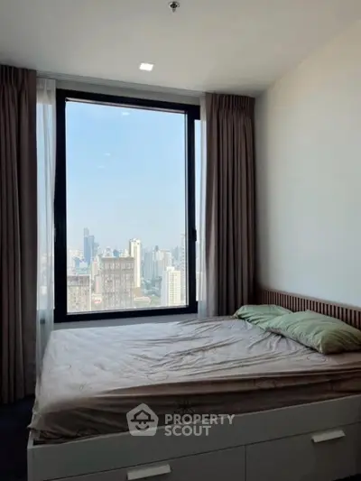 Modern bedroom with large window offering stunning city view