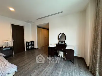 Spacious bedroom with elegant wooden furniture and ample natural light