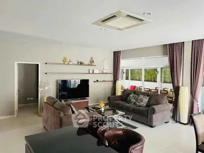 Spacious living room with modern furniture and large windows for natural light.