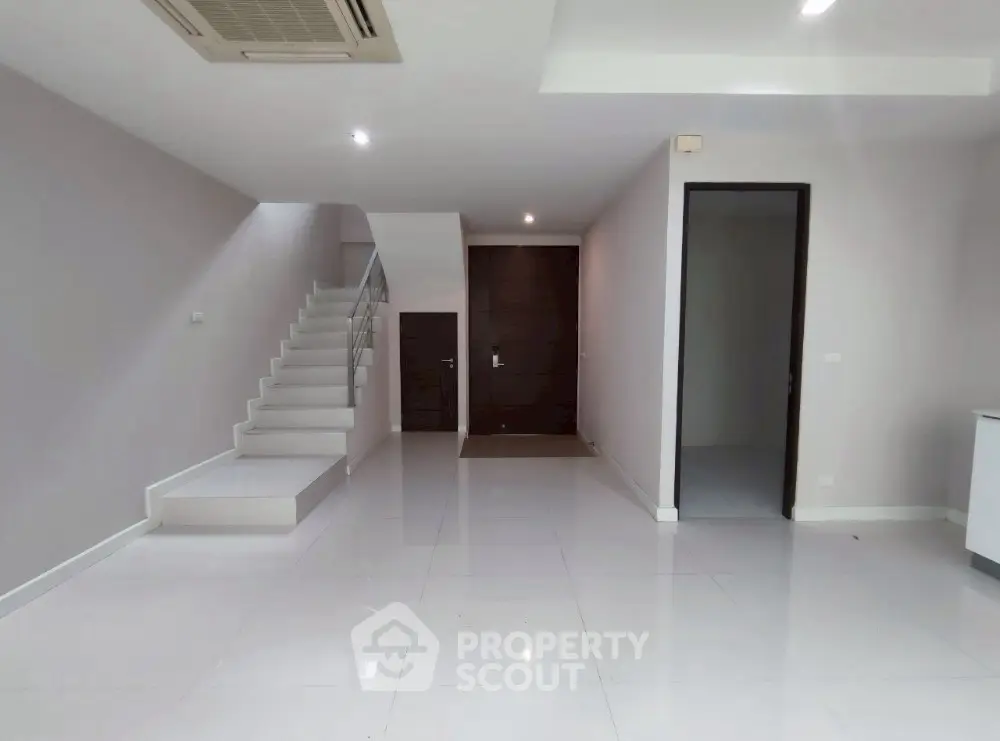 Spacious modern interior with sleek staircase and minimalist design