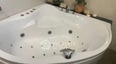 Luxurious corner bathtub with modern fixtures in elegant bathroom setting.