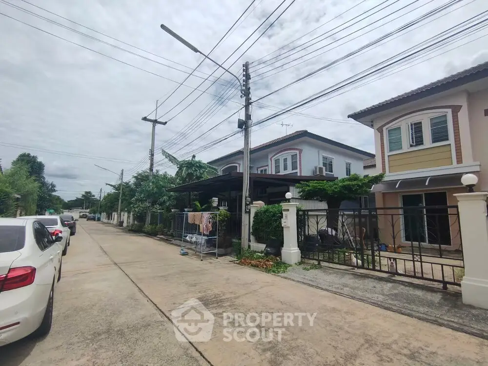 Charming suburban street with modern houses and lush greenery, perfect for family living.