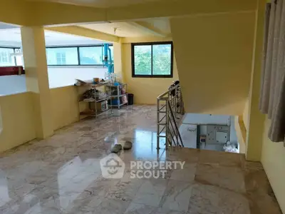 Spacious interior with marble flooring and large windows offering natural light.