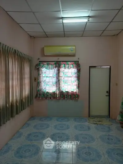 Cozy room with air conditioning and patterned curtains, ideal for a comfortable living space.