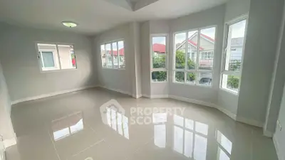 Spacious empty room with large windows and glossy tiled floor